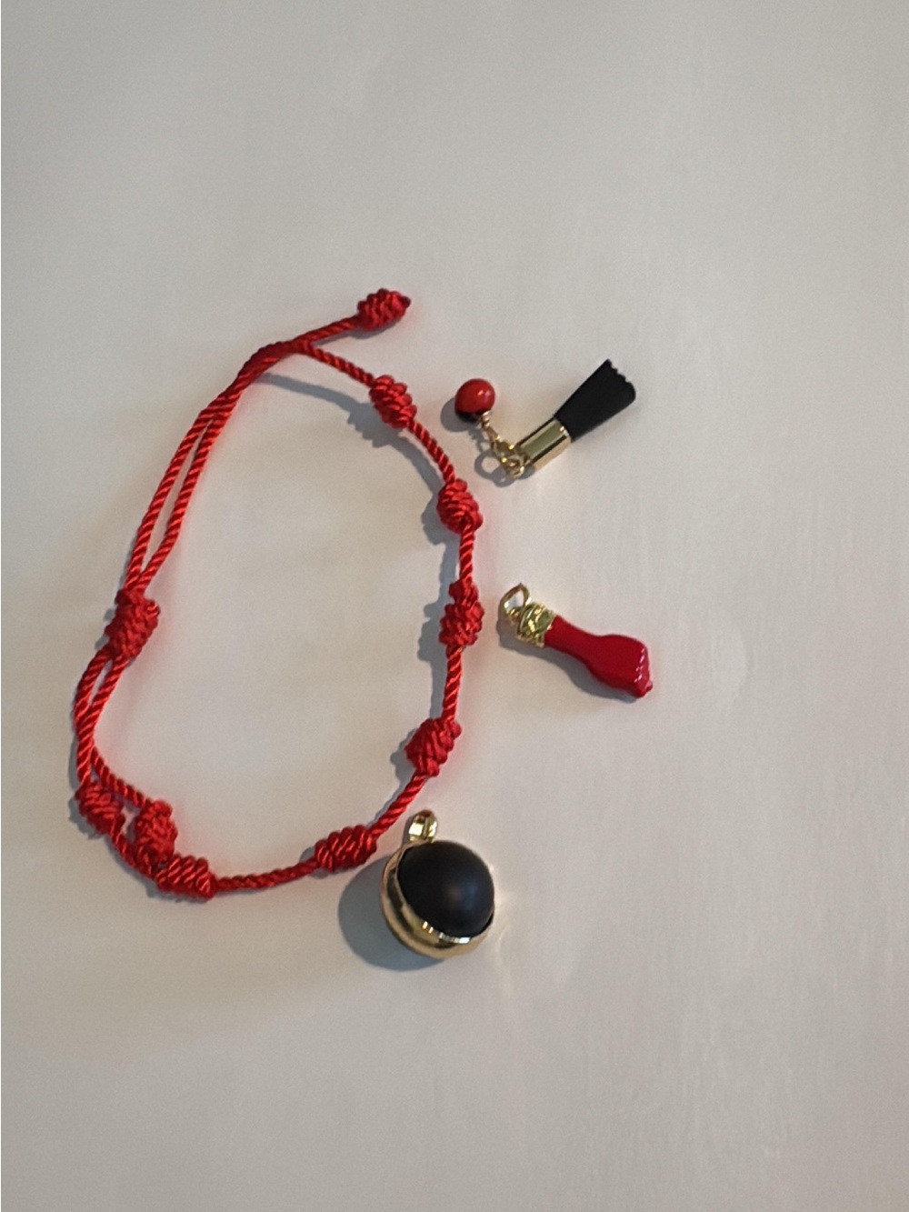 Red Knotted Cord bracelet with Black Pendant and Accent Charms